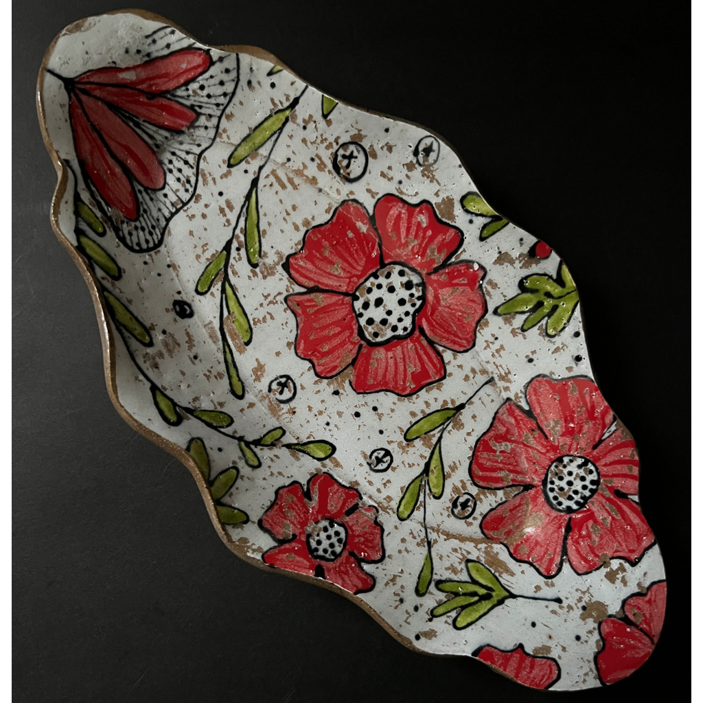 diagonal view of rustic red floral oval serving dish